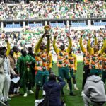 Senegal's players parade with The African Cup of Nations trophy ahead of the international friendly football match between Senegal and Peru at the Stade de France in Saint-Denis, north of Paris on March 28, 2026. (Photo by JULIEN DE ROSA / AFP)